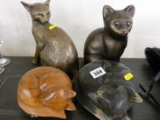 Four cat figurines, various composition