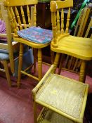Two light wood spindleback bar stools and a two tier bamboo stand