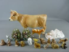 Royal Doulton figurine 'New Baby' HN3712, a Melba ware cow, a Beswick calf and a quantity of Wade