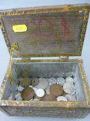 Repousse brass tea caddy containing a quantity of British and overseas vintage coinage