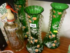 Three green glass enamel decorated vases and a Britannia advertising soda water syphon