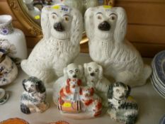 Three pairs of Staffordshire comforter dogs and a flatback figurine depicting two dogs with a