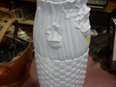 Plain white ceramic stickstand with miscellaneous contents