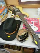 Fenton Weill electric guitar, a leather belt with John Wayne buckle, a Stetson type hat and a guitar