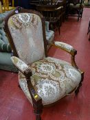 Late Victorian walnut salon armchair with carved detail on turned and reeded front supports with