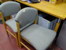 Two modern upholstered chairs and a stylish rectangular desk style table