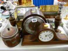 Two vintage mantel clocks, a pair of oak and chrome candlesticks with a similar tea jar and cover