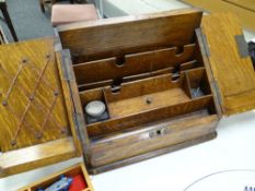 A vintage oak slope front compartmented stationary cabinet Condition reports provided on request