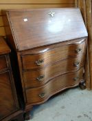 A serpentine front sloped bureau on ball and claw supports Condition reports provided on request