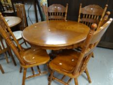 Modern circular breakfast table together with four matching spindle back chairs, 106cms diam. (5)