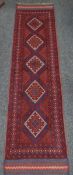 A rust coloured and blue Meshwani runner, 248 x 61cms Condition reports provided on request by email