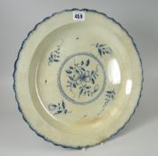 An early nineteenth century floral decorated creamware charger dish with blue combed decoration to