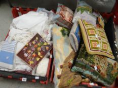 Two crates containing various linen and embroidered cushions Condition reports provided on request