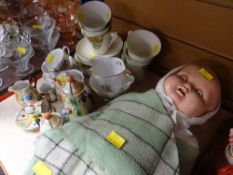 A vintage composition doll and a parcel of souvenir and other teaware Condition reports provided