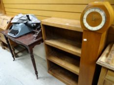 A vintage lightwood open bookcase, a lightwood grandmother clock and a mahogany writing desk (