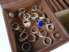 A modern jewellery box with drawers containing a collection of white metal / silver dress rings,