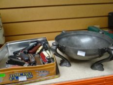 An English pewter Art Nouveau-style four-footed bowl together with a tin of vintage pen knives