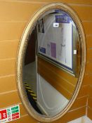 A vintage oval bevelled wall mirror Condition reports provided on request by email for this