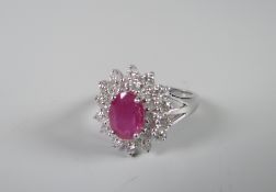 An 18ct white gold set ruby (1ct approx.) and diamonds (1ct total) floral ring Condition reports