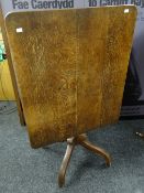 An antique rectangular oak tilt-top table on a turned column and four footed base, 89 x 75cms