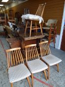 A set of four spindle back mid-century lightwood chairs, an occasional table with reeded supports
