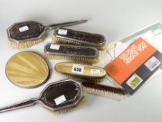 A four-piece silver and tortoiseshell dressing table set (distressed) together with a Guilloche