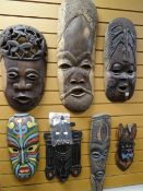 Collection of seven carved grotesque native-arts tribal masks, some with painted designs Condition