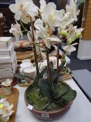 An artificial plant in a pot Condition reports provided on request by email for this auction