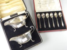 A cased pair of silver sauce boats with crimped rim and three pad feet, 6oz together with a cased