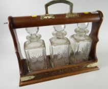 A three-bottle vintage tantalus Condition reports provided on request by email for this auction