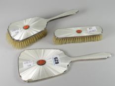A three-piece Guilloche enamel and silver brush and mirror set, each elements set with centred