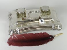 A good silver desk stand of shaped form on bun feet and with two square based glass inkwells with