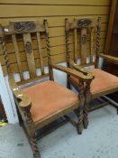 A pair of carved Art Nouveau-style decorated barley-twist and splat back oak armchairs with drop