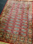 A red ground medallion patterned Persian carpet, 208cms long Condition reports provided on request