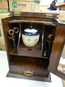 A smoker's cabinet and contents including mixing jar and two pipes Condition reports provided on