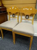 Pair of biedermeier-style birch-wood dining chairs raised on splayed legs with O design splat