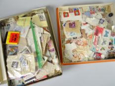 A tin & a vintage chocolate containing loose stamps Condition reports provided on request by email