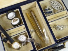 A monogrammed vintage jewellery box containing various items including watches, propelling