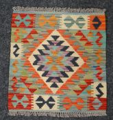 A small square rug, 54 x 52cms Condition reports provided on request by email for this auction
