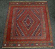 A rust and blue patterned Gazak rug, 132 x 121cms Condition reports provided on request by email for