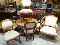 Mixed wood circular breakfast table together with set of four spoon-back dining chairs and open