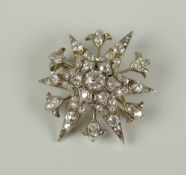 DIAMOND ENCRUSTED STARBURST BROOCH / PENDANT, having central stone (0.3ct approx.) surrounded by
