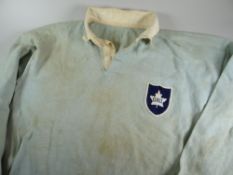 A 1957 ONTARIO RUGBY UNION JERSEY NUMBERED 18 having a birds-egg blue body with white collars and