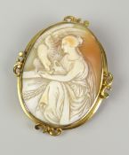 CARVED CAMEO BROOCH DEPICTING ROBED LADY WITH BIRD OF PREY in yellow metal setting Condition Report: