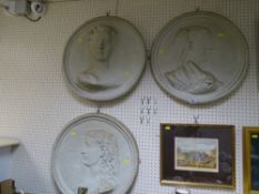 Three circular cast stoneware plaques of ladies