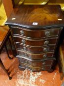 Reproduction narrow serpentine fronted chest of drawers and a dralon footstool