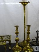 Pair of circular based tall brass candle holders and a circular based brass smoker's companion
