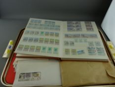 Hardback stamp album containing some modern commemorative stamps, small parcel of first day covers