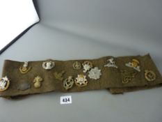 Approximately twenty five military uniform badges, various regiments etc