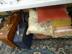 Parcel of mixed cushions and two suitcases